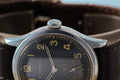 Detailed view of ETERNA WWII military wristwatch, vintage 36.5mm dial, unique features, historical rarity
