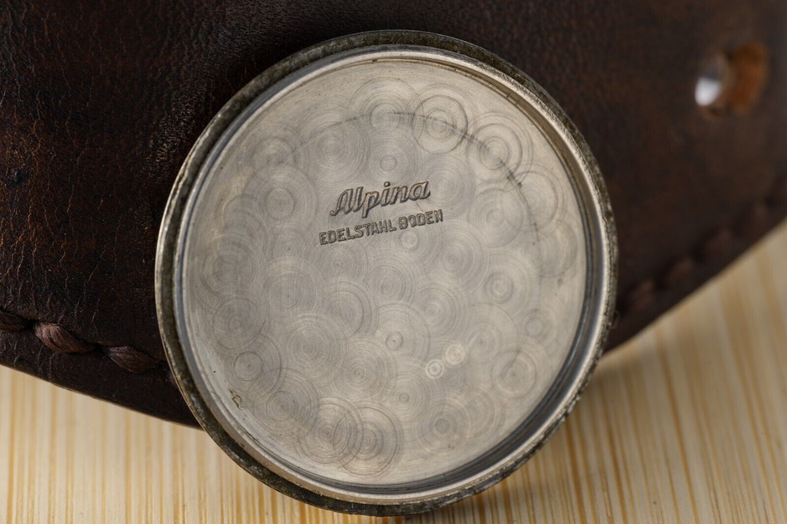 Back engraving of KM Alpina 592 WWII wristwatch, Swiss heritage, collectible vintage piece